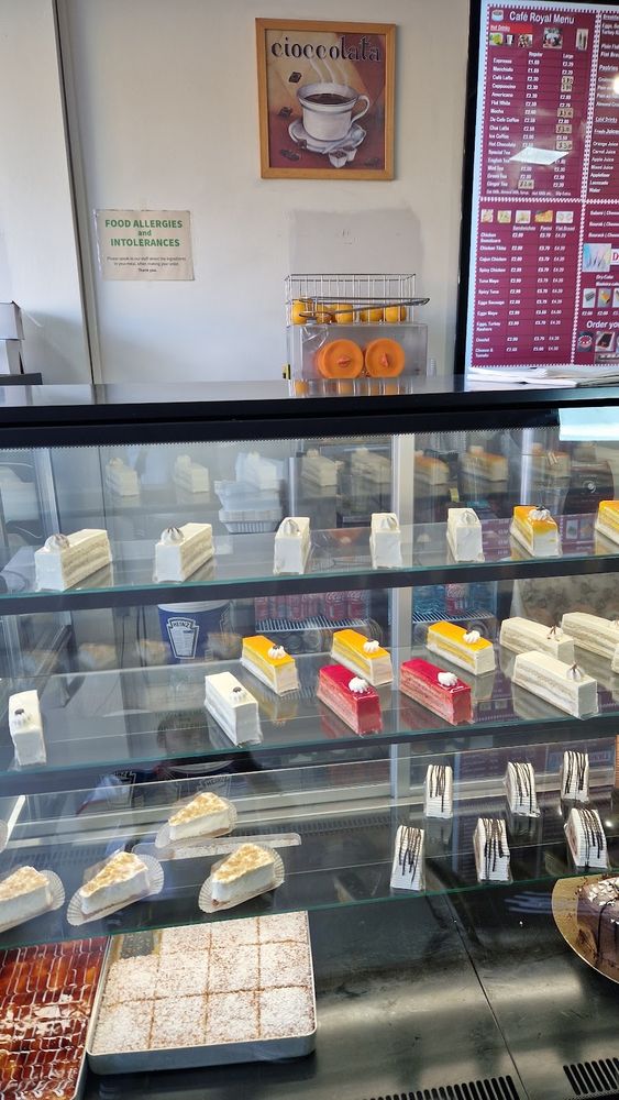 Interior corner of the cafe with the cake cabinet against the wall.